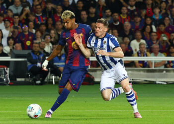 Barca down Real Sociedad to go top of La Liga