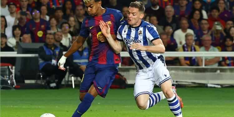 Barca down Real Sociedad to go top of La Liga